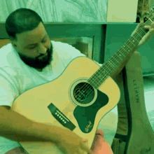DJ Khaled playing the guitar